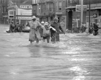 Rescue at Market and Cameron: Evacuees and rescue workers fight against the current from the Paxton Creek as it flows down Cameron Street.