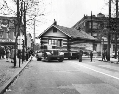 Truck Moving a Log Cabin